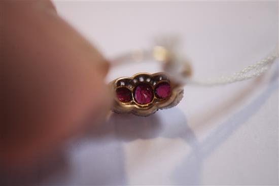 A gold, ruby and diamond triple cluster ring, size K.
